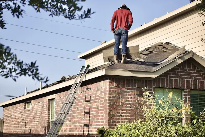 Professional roofer working on a residential roof in North High Shoals